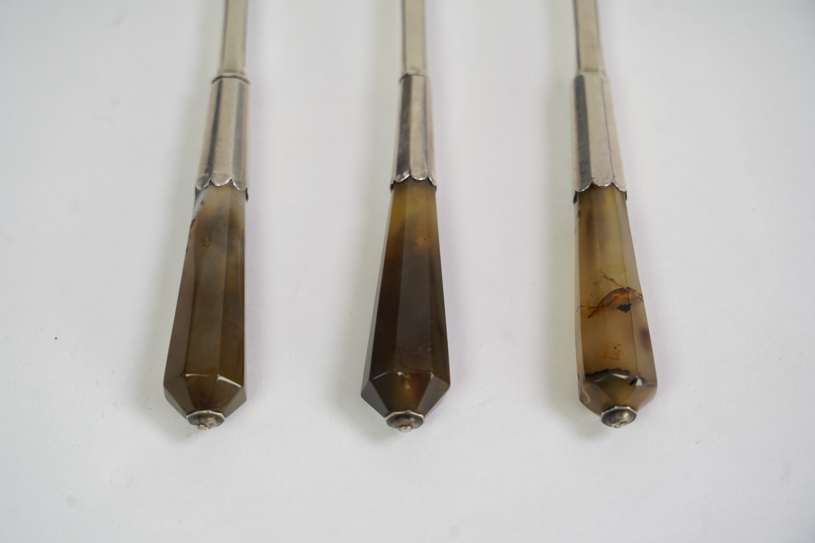 A set of three late Charles II agate handled silver three pronged forks, maker TZ with crown above and mullet below, (Jackson's ref. p.139)